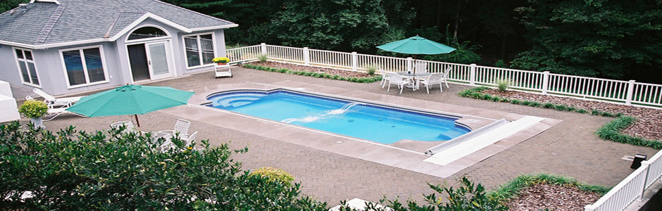 Swimming pool beside a gray pavilion and spacious paved deck